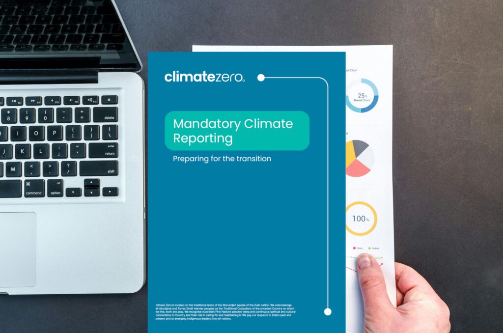 Mandatory climate report on desk with macbook