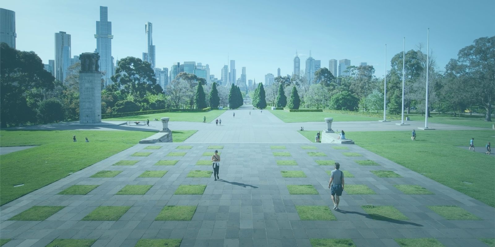 Image of park with a path towards a city